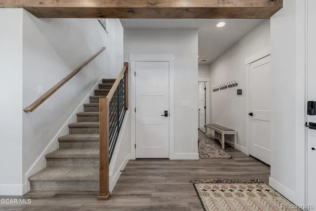 a view of a hallway with wooden floor and entryway