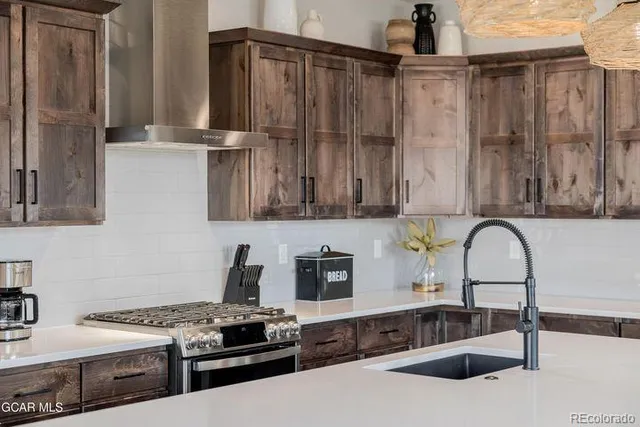 a kitchen with stainless steel appliances and cabinets