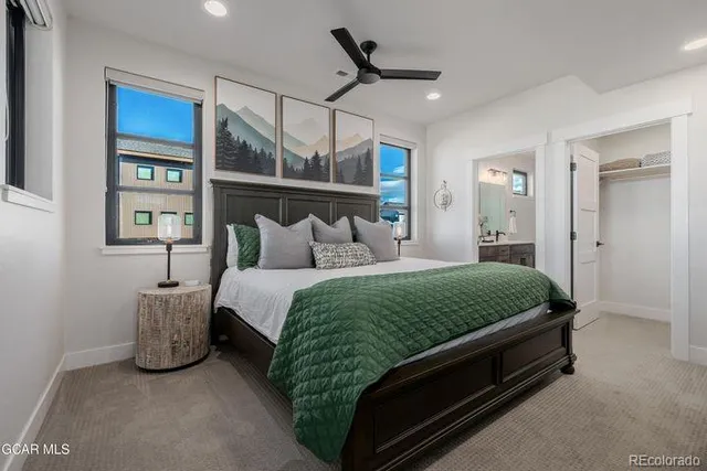 a bedroom with a bed lamp and window