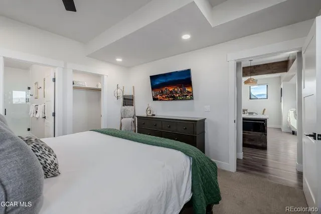 a bedroom with a large bed and a chandelier