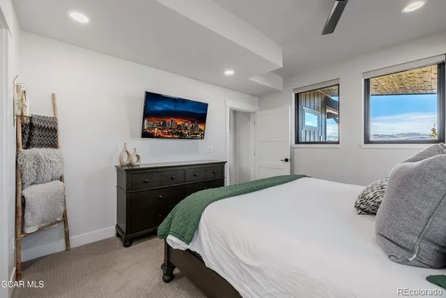 a bedroom with a bed and a painting on the wall