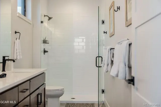a bathroom with a sink toilet and shower