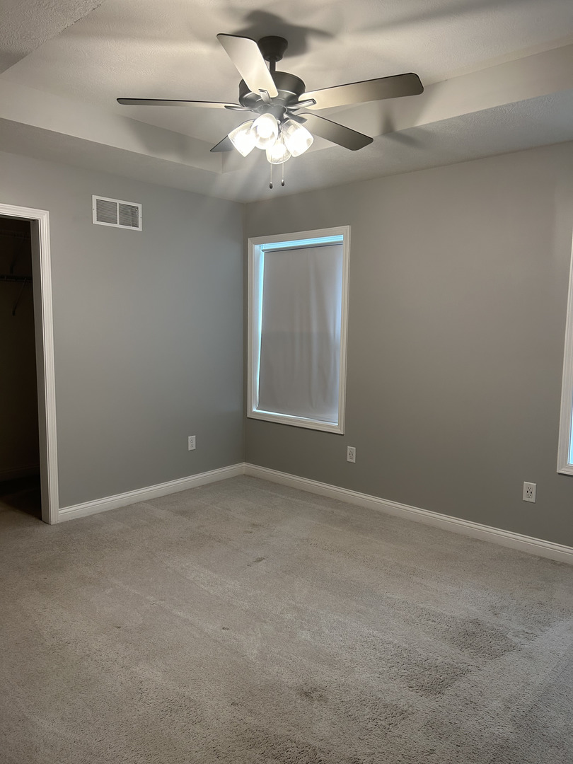 35 Winding Way Bloomington, IL 61705 - Photo 5 of 9 a view of an empty room with a chandelier fan