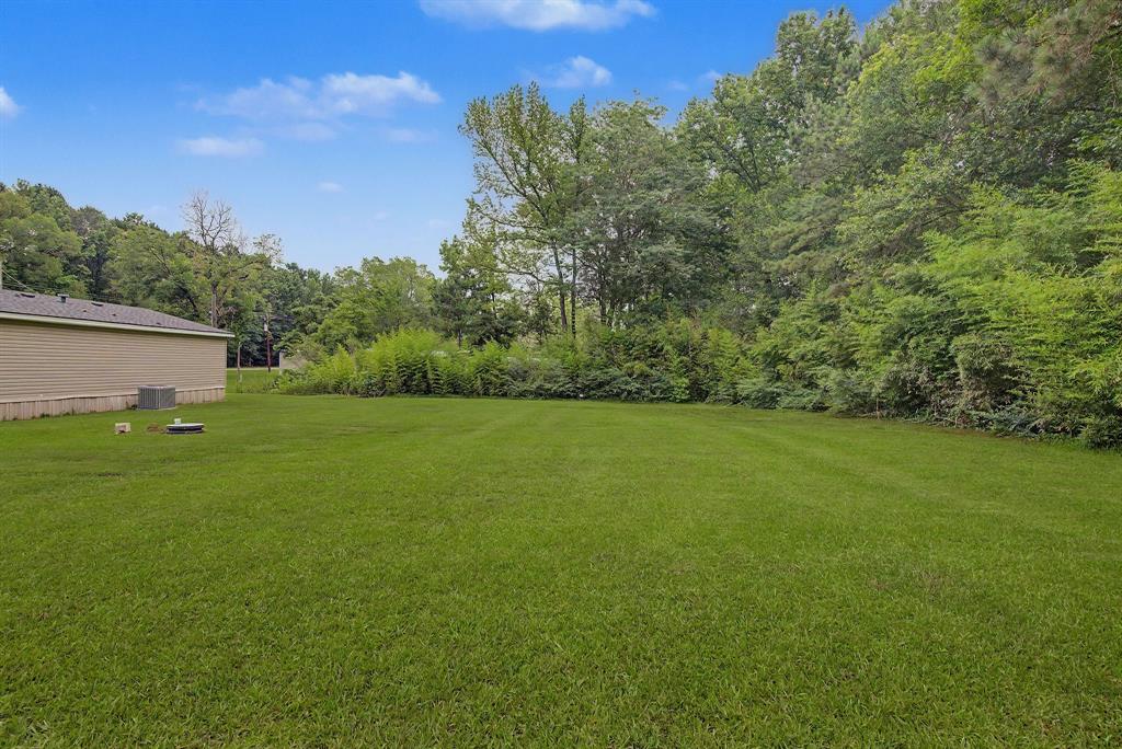 1202 Princeton Road Princeton, LA 71067 - Photo 18 of 19 Expansive green lawn with a tree-lined perimeter