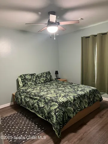 a bed sitting in a bedroom next to a window