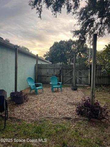 a backyard of a house with lots of green space and outdoor seating