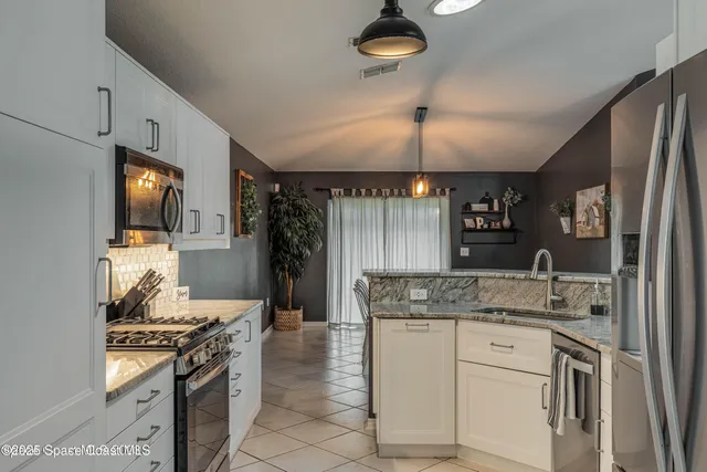 a kitchen with a sink stove and refrigerator