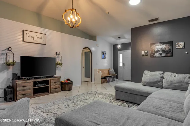 a living room with furniture and a flat screen tv