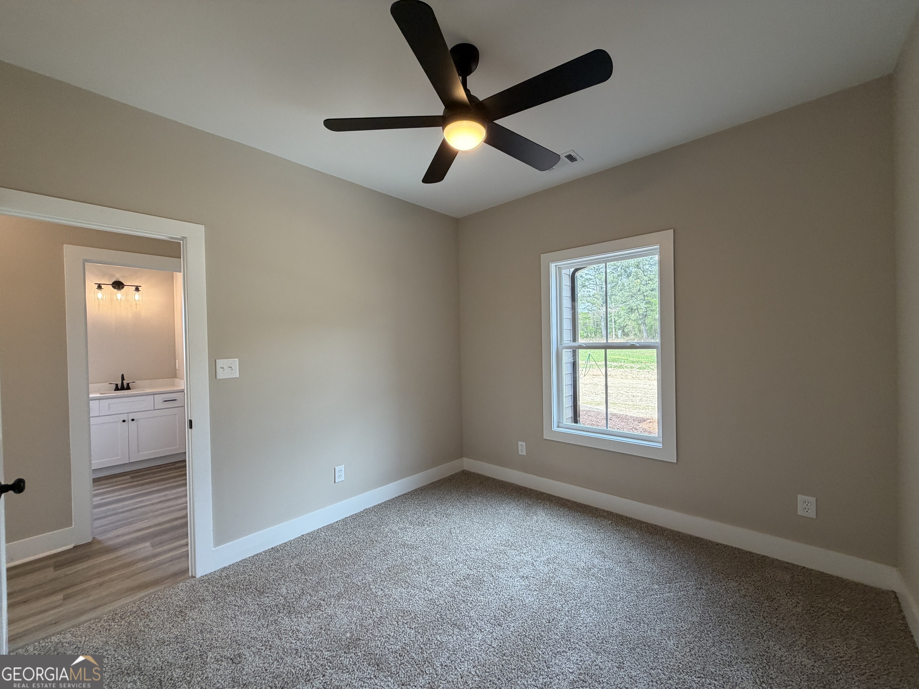 54 Melville Brown Road Williamson, GA 30292 - Photo 12 of 16 an empty room and window with a fan