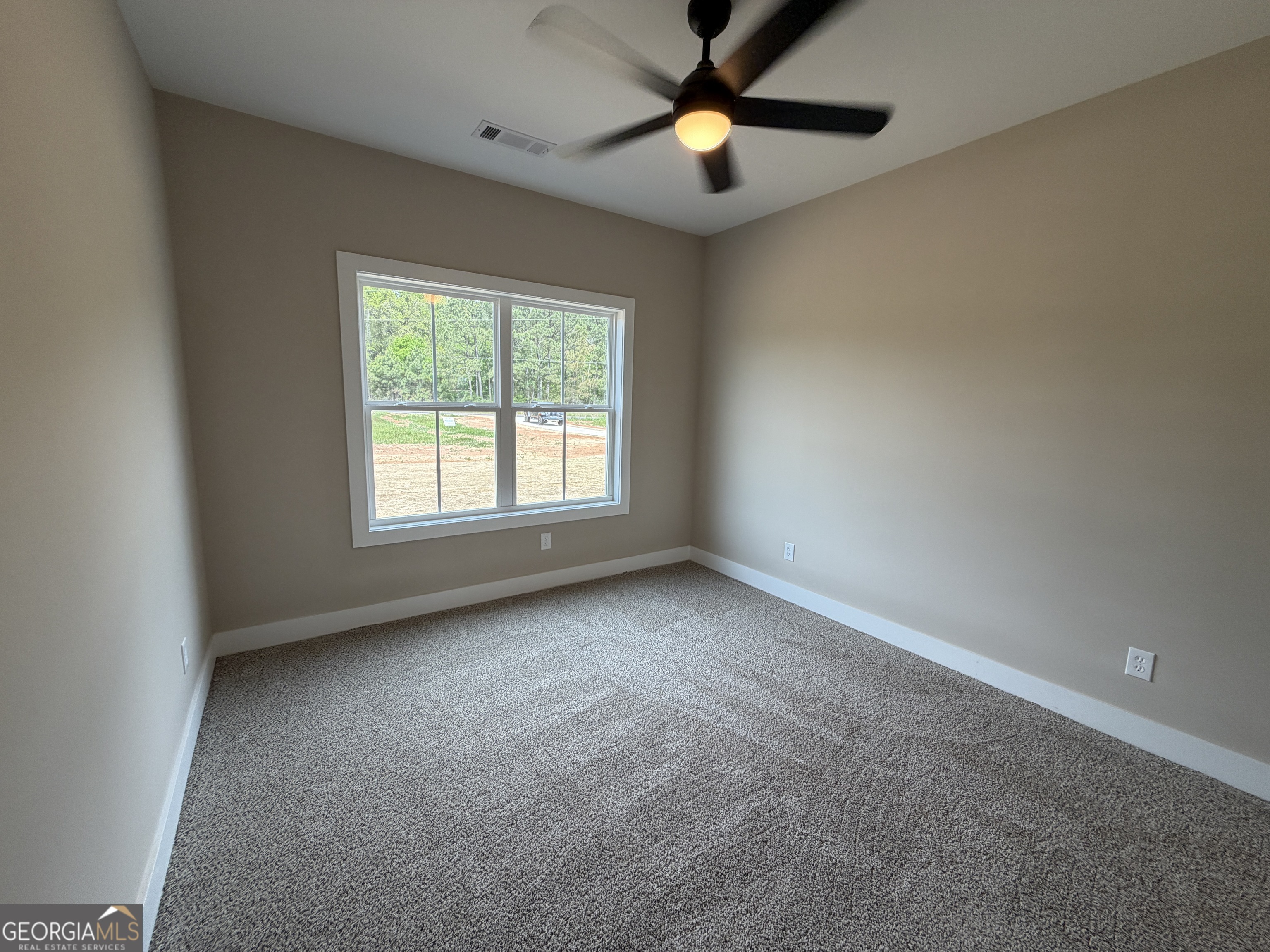 54 Melville Brown Road Williamson, GA 30292 - Photo 13 of 16 an empty room with a window and a fan