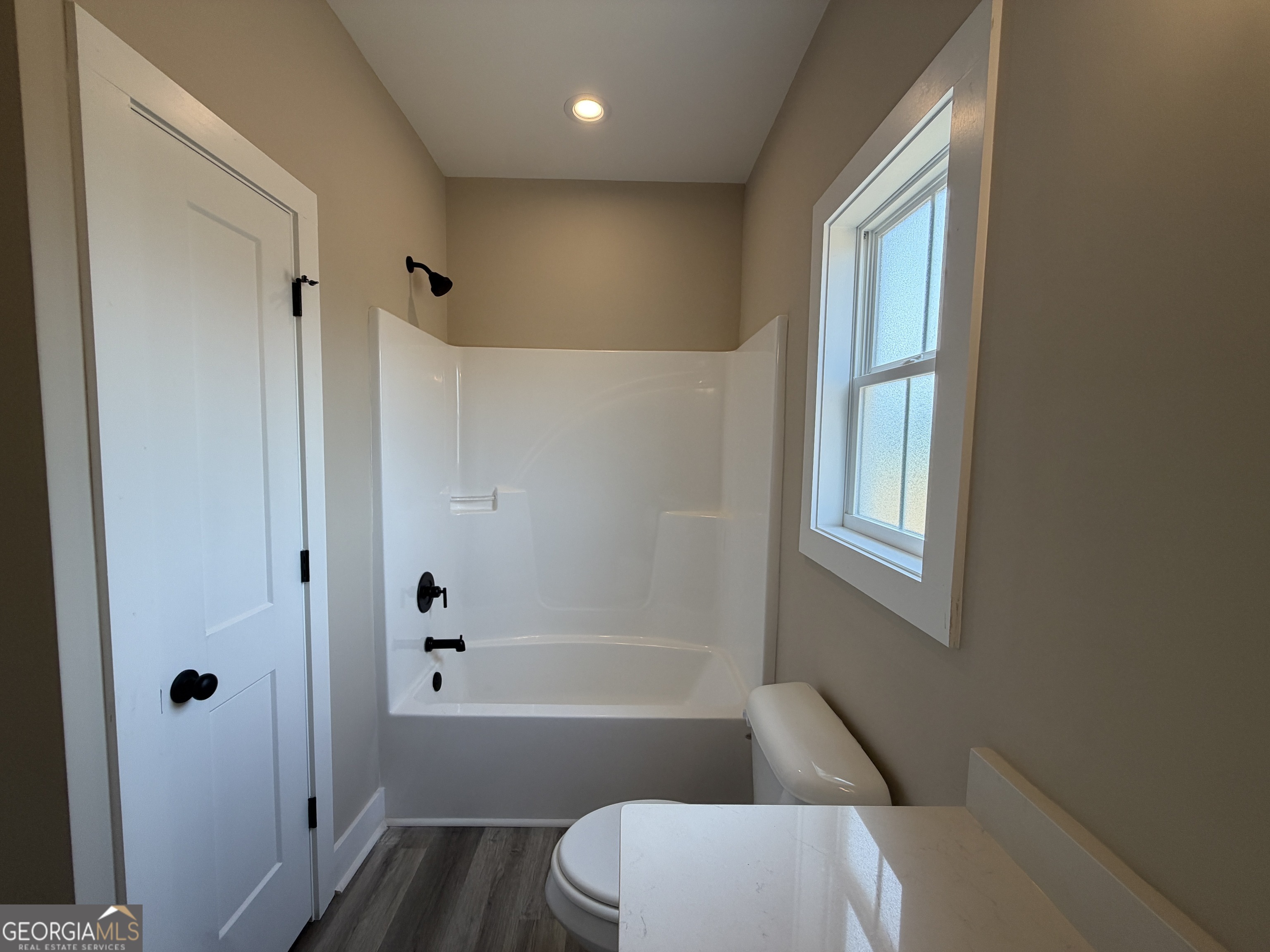 54 Melville Brown Road Williamson, GA 30292 - Photo 14 of 16 a bathroom with a bathtub toilet and window