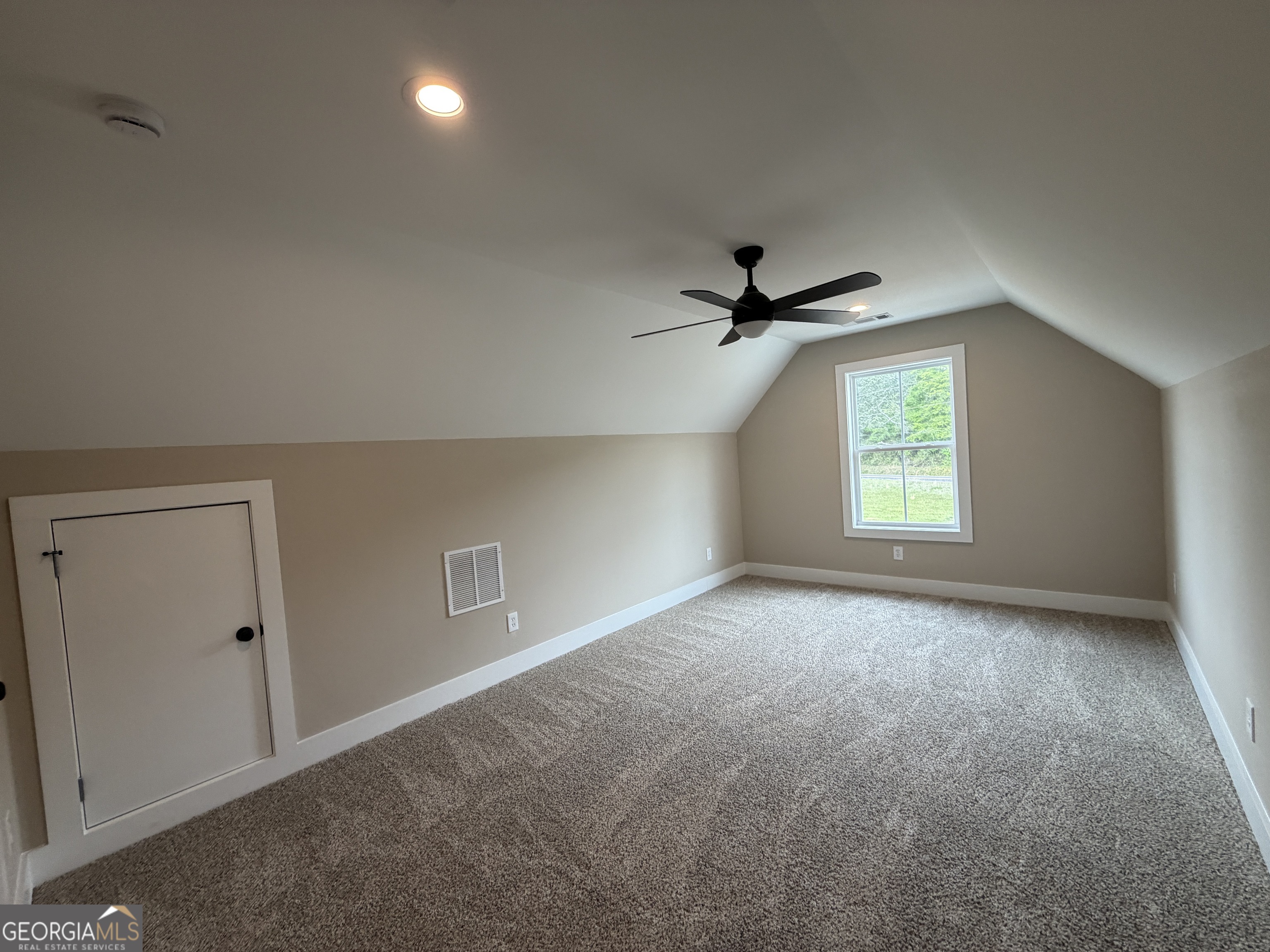 54 Melville Brown Road Williamson, GA 30292 - Photo 16 of 16 an empty room with a window and a fan