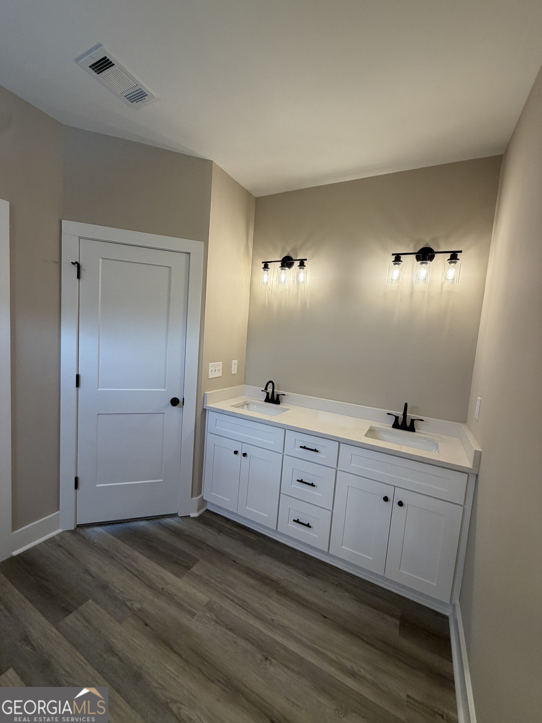 54 Melville Brown Road Williamson, GA 30292 - Photo 9 of 16 a bathroom with a double vanity sink and mirror