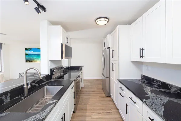 a kitchen with a sink stove and refrigerator