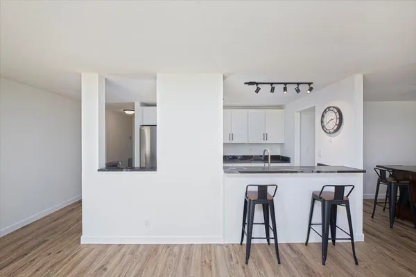 a view of a dining room with a table and chairs