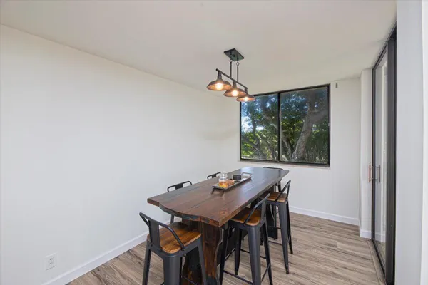 a view of a dining room with furniture wooden floor and a chandelier