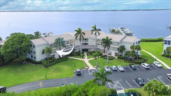 an aerial view of a house with a yard and potted plants
