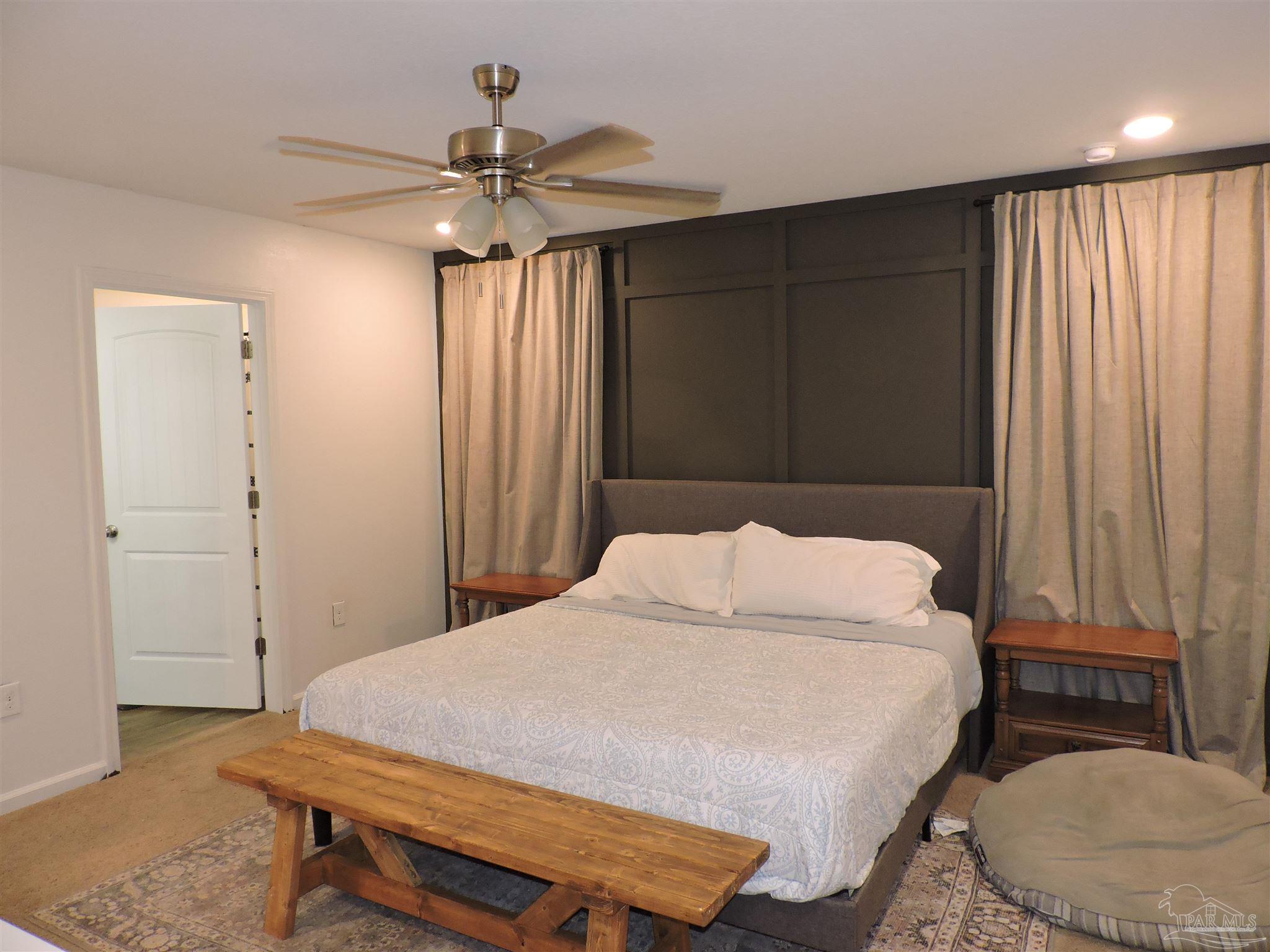 5840 Paddock Way Pensacola, FL 32526 - Photo 13 of 21 a bedroom with a bed and a chandelier