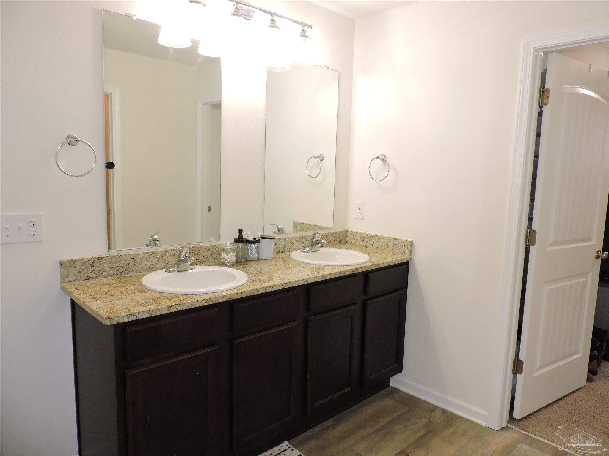 5840 Paddock Way Pensacola, FL 32526 - Photo 16 of 21 a bathroom with a granite countertop sink and a mirror