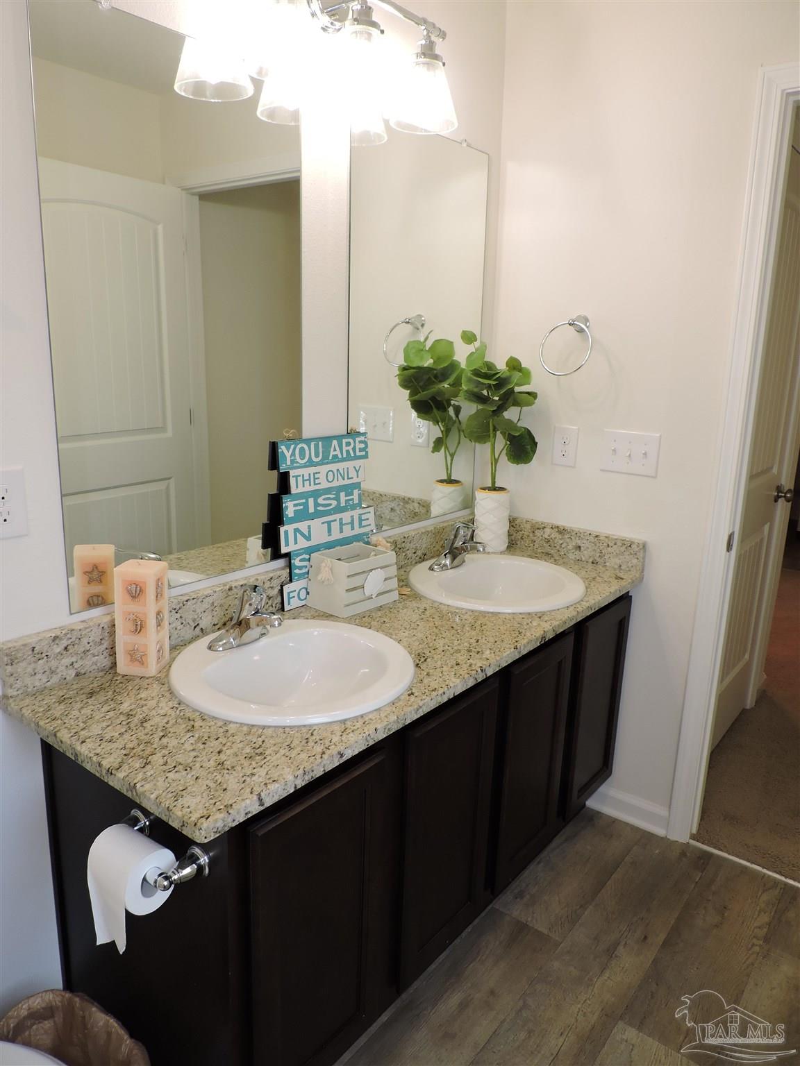 5840 Paddock Way Pensacola, FL 32526 - Photo 19 of 21 a bathroom with a granite countertop sink and a mirror
