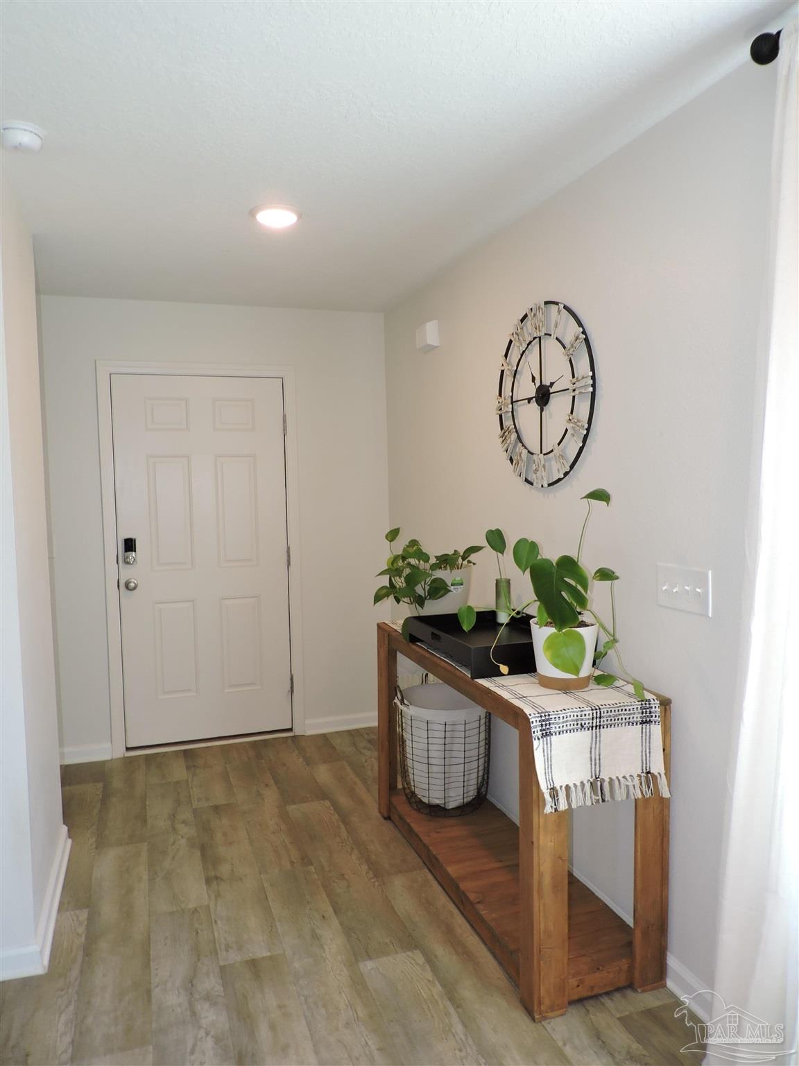 5840 Paddock Way Pensacola, FL 32526 - Photo 2 of 21 a room with a table and a chair