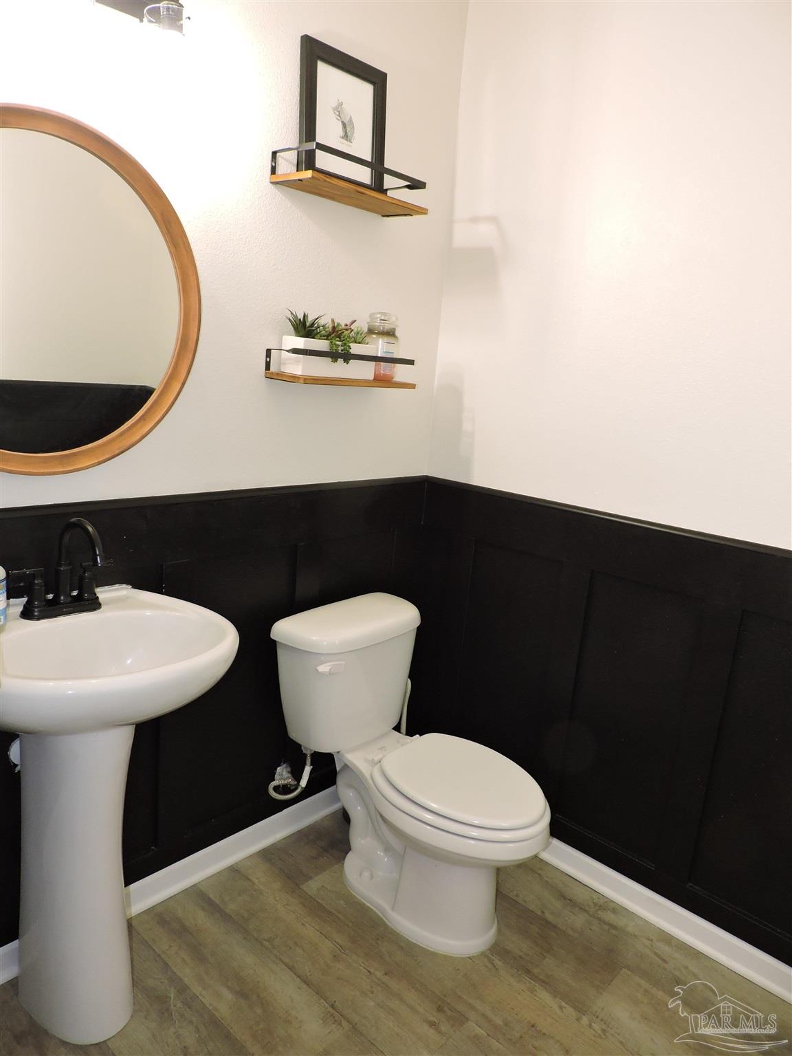 5840 Paddock Way Pensacola, FL 32526 - Photo 3 of 21 a white toilet sitting next to a bathroom sink