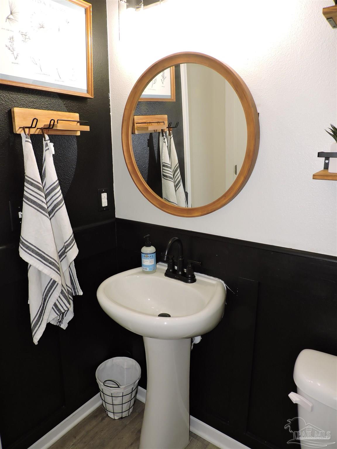 5840 Paddock Way Pensacola, FL 32526 - Photo 4 of 21 a bathroom with a sink and a mirror