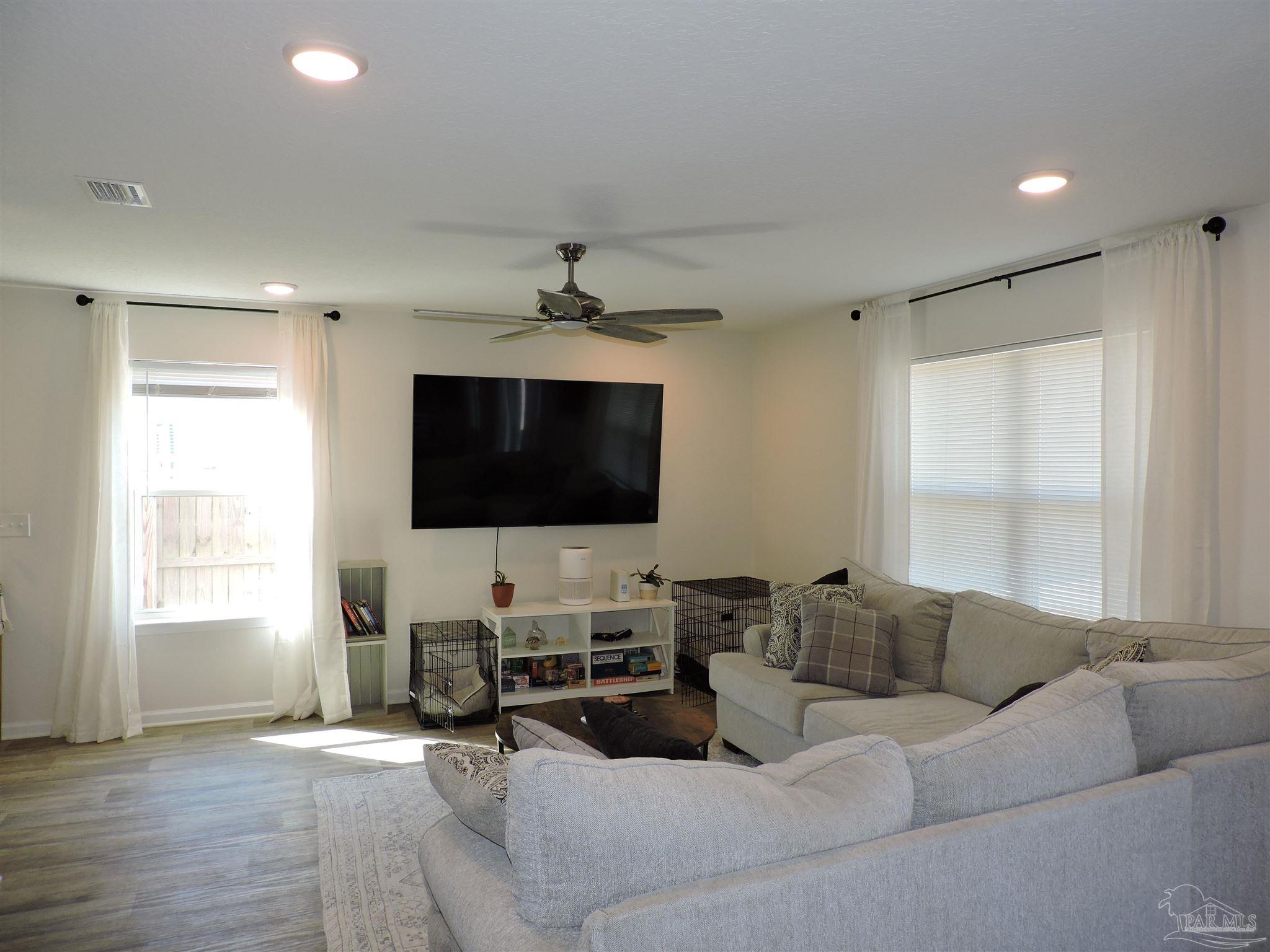 5840 Paddock Way Pensacola, FL 32526 - Photo 5 of 21 a living room with furniture and a flat screen tv