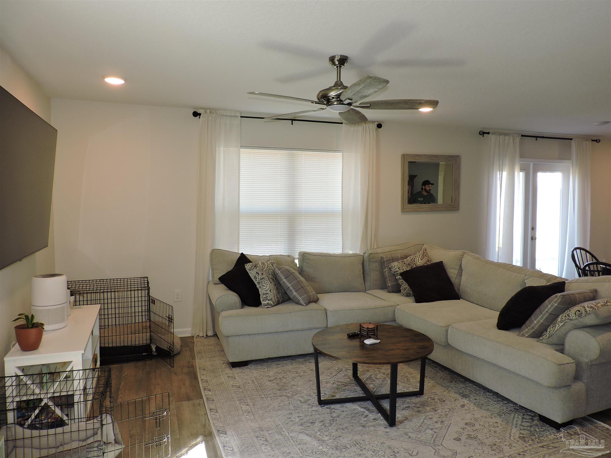 5840 Paddock Way Pensacola, FL 32526 - Photo 7 of 21 a living room with furniture and a flat screen tv