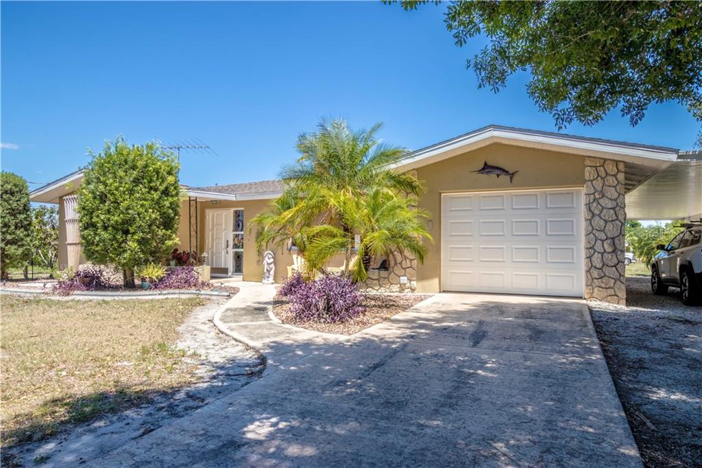 3106 Maplewood Road Punta Gorda, FL 33982 - Photo 1 of 1 a front view of a house with garden