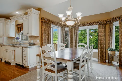 a view of a dining room with furniture wooden floor and chandelier