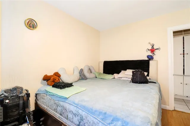 a bedroom with a bed and a potted plant