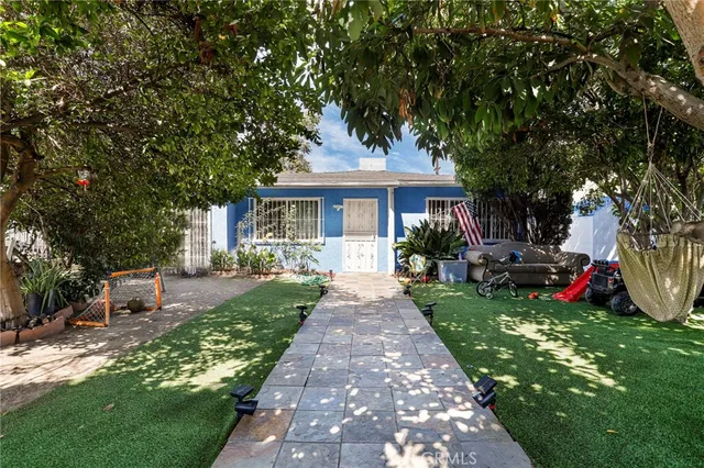 a front view of a house with a garden