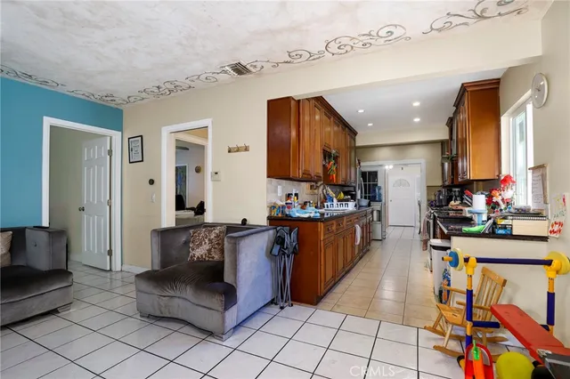 a living room with furniture and a kitchen