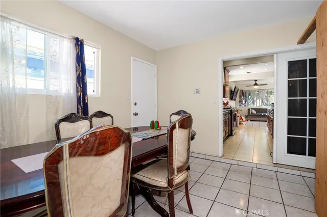 a living room with furniture a flat screen tv and view of kitchen