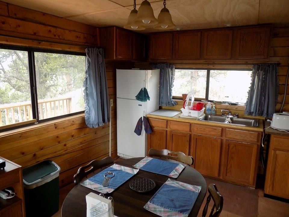 419 Osprey Road Como, CO 80432 - Photo 8 of 31 a kitchen with sink refrigerator and window