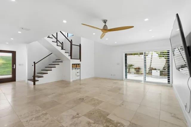a bathroom with a tub a sink and a large mirror