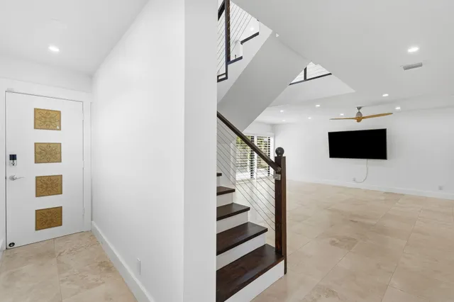 a view of a livingroom with stairs and furniture