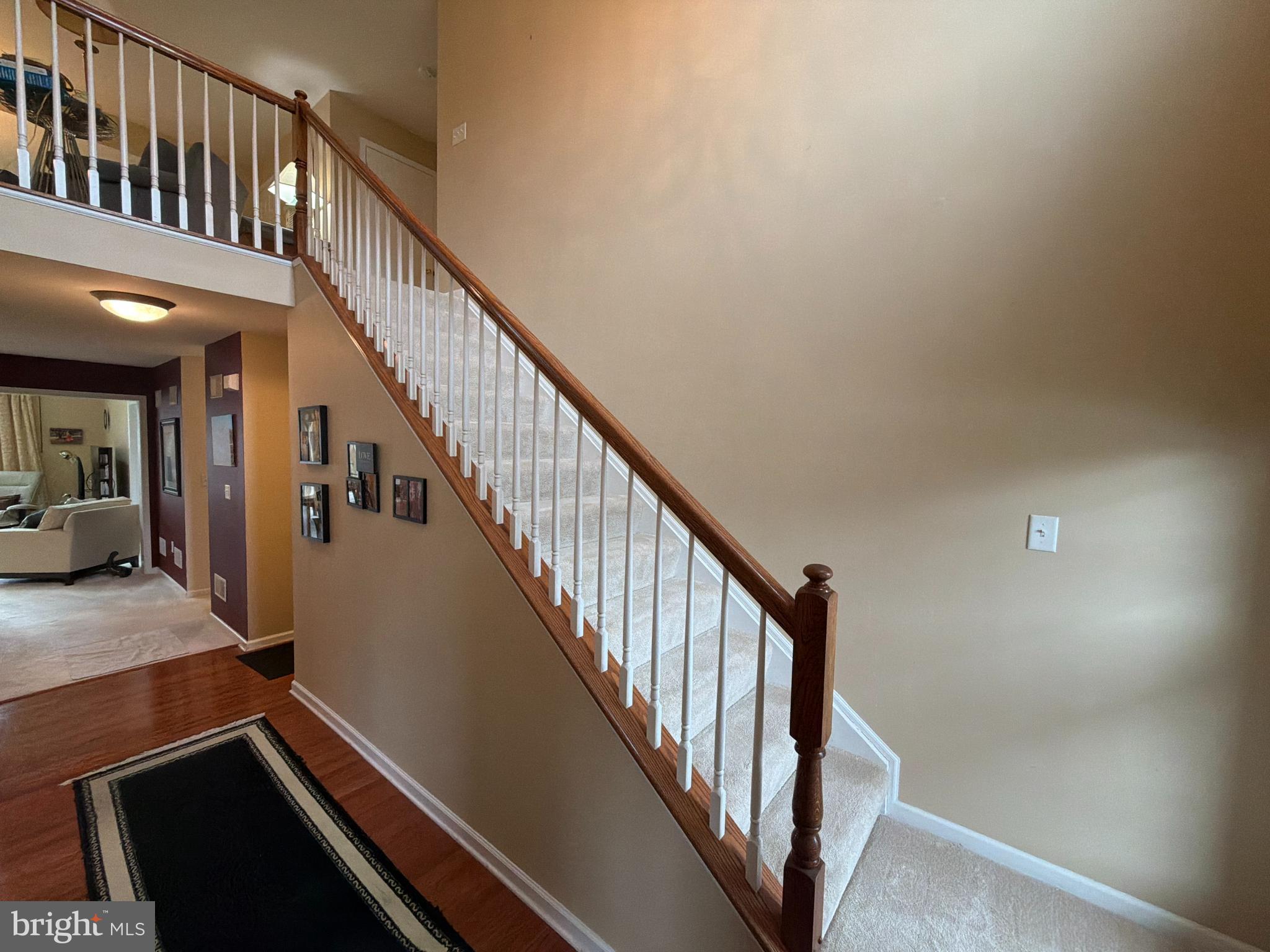 4245 Roth Farm Village Circle Mechanicsburg, PA 17050 - Photo 24 of 42 a view of staircase with lots of frames on wall and a window
