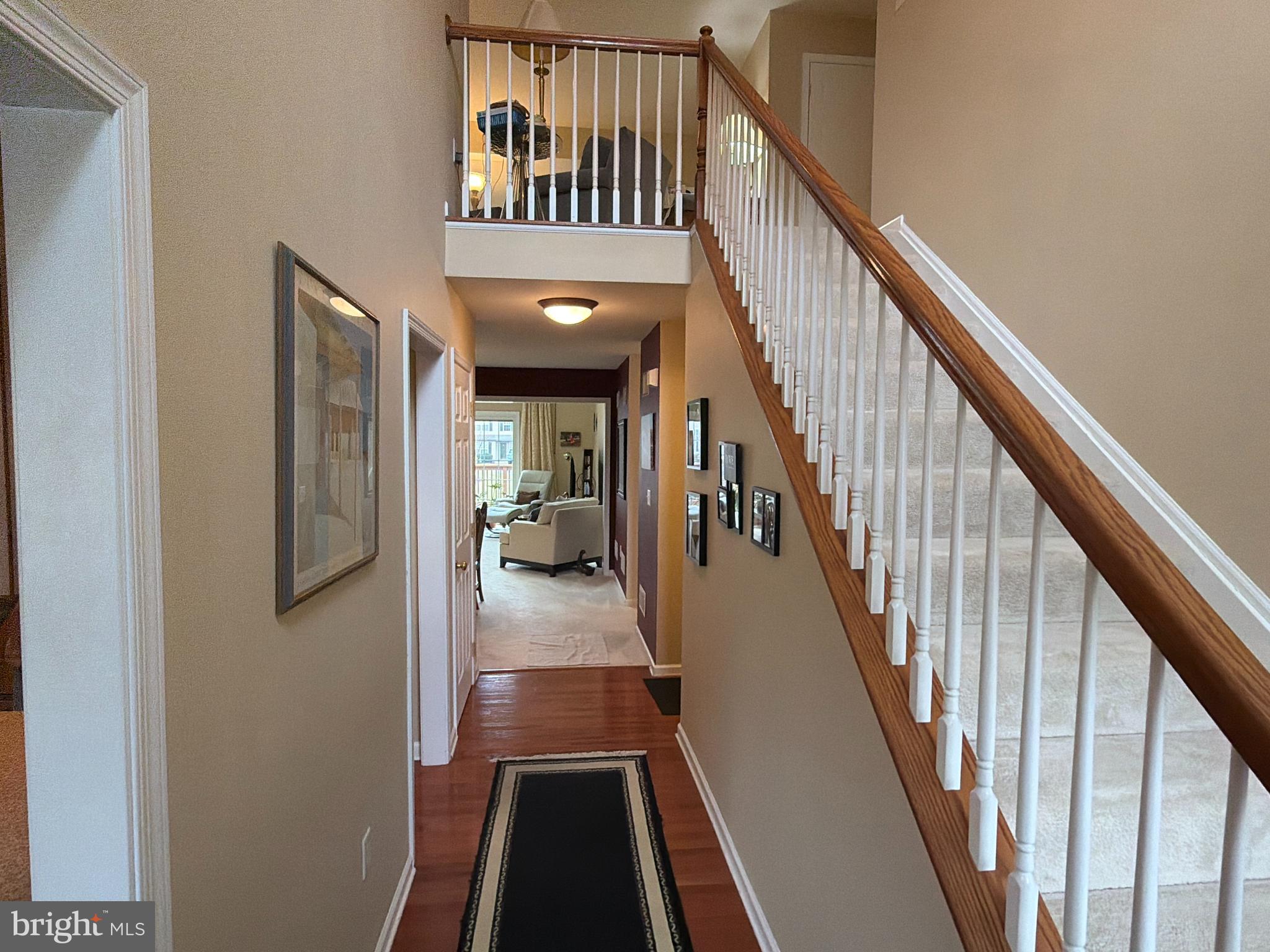 4245 Roth Farm Village Circle Mechanicsburg, PA 17050 - Photo 4 of 42 a view of staircase with lots of frames on wall and a window
