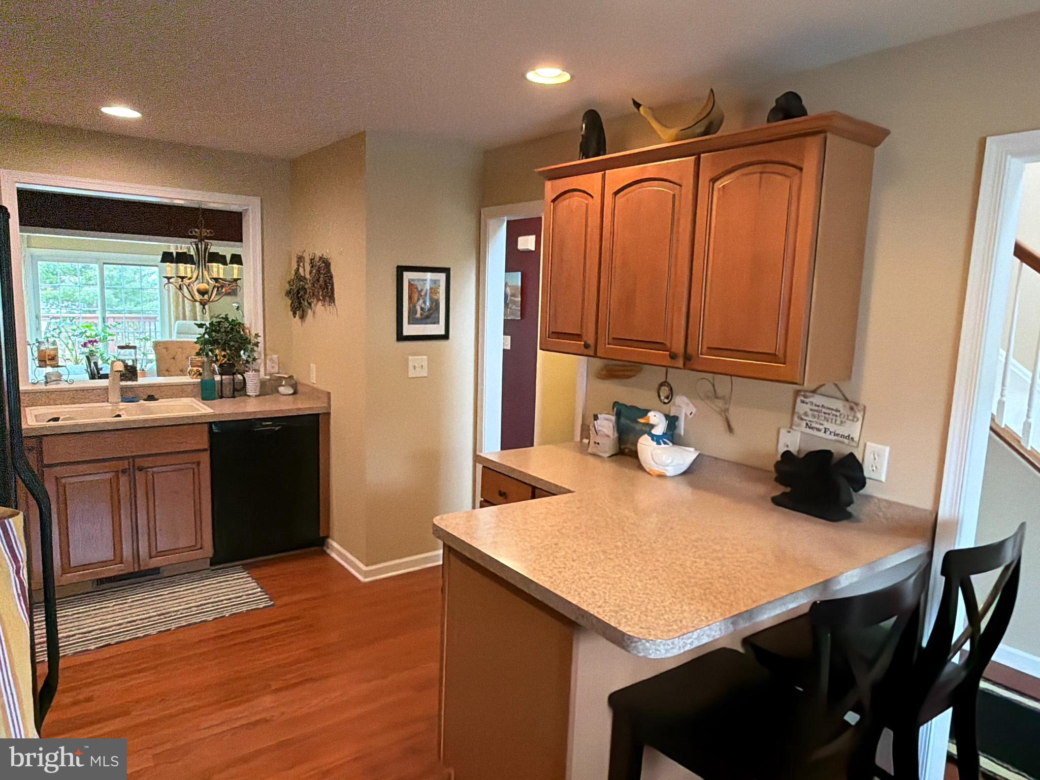 4245 Roth Farm Village Circle Mechanicsburg, PA 17050 - Photo 7 of 42 a kitchen with stainless steel appliances a sink a stove and wooden floor