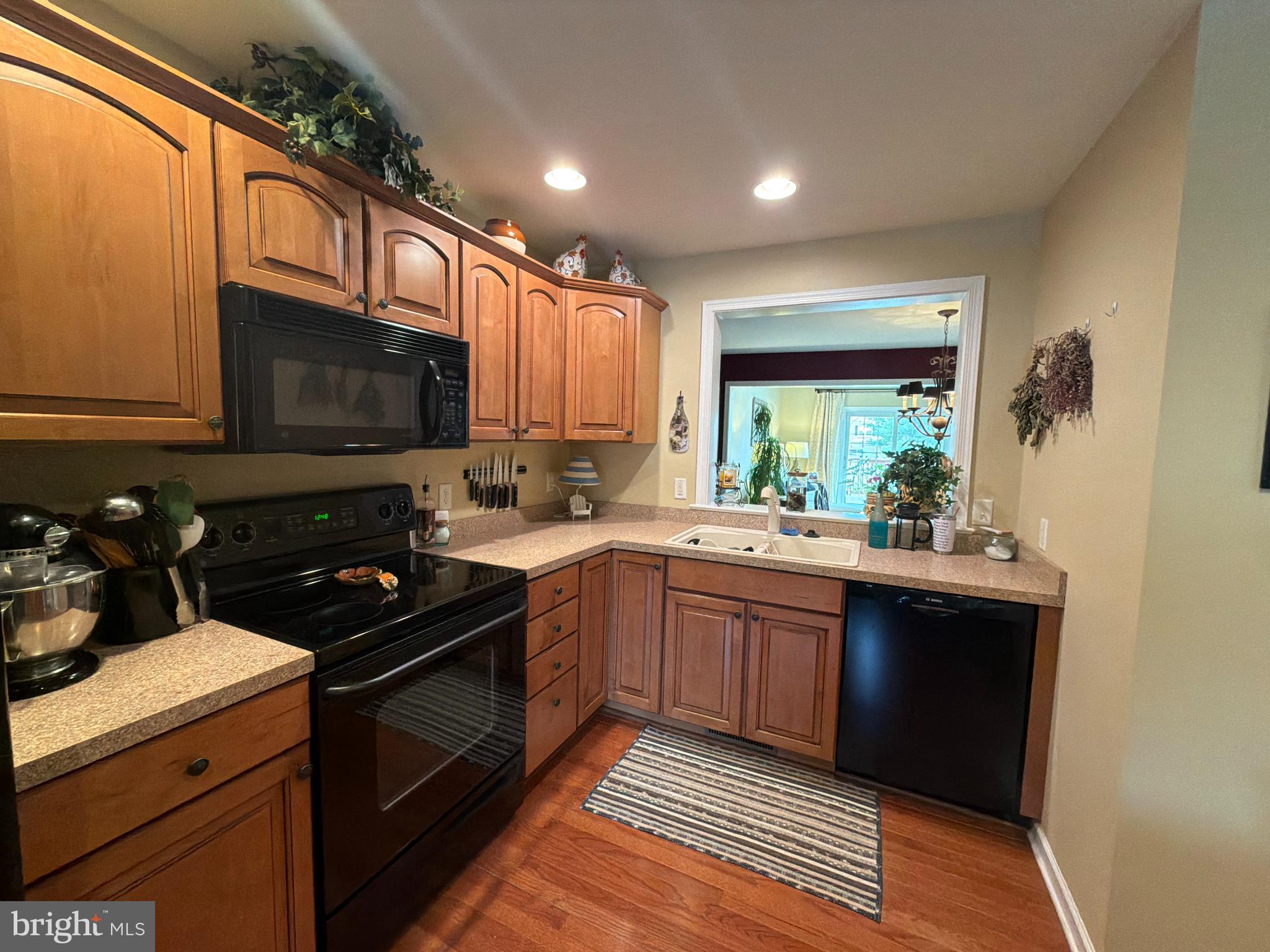 4245 Roth Farm Village Circle Mechanicsburg, PA 17050 - Photo 8 of 42 a kitchen with stainless steel appliances granite countertop a stove a sink and a microwave
