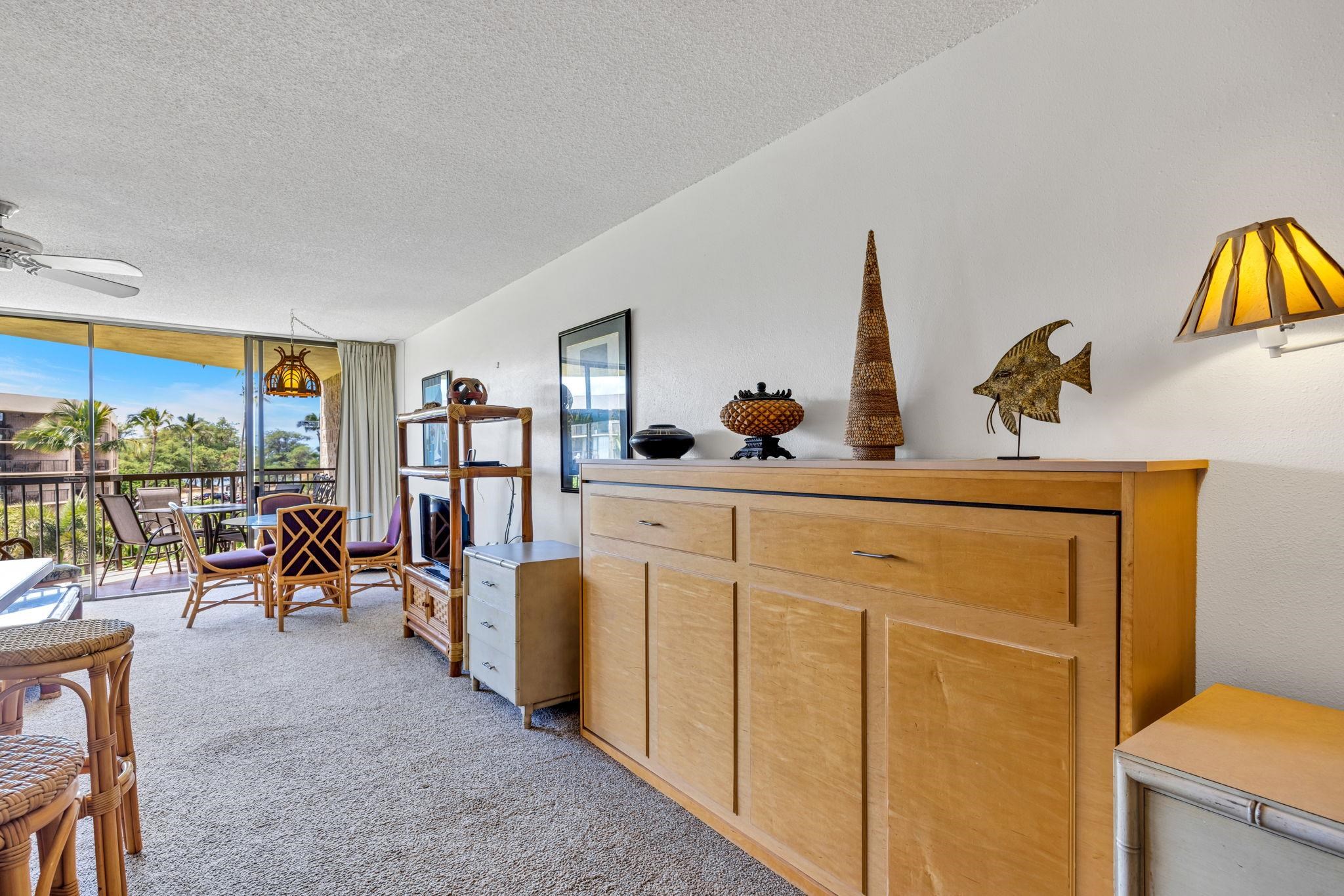 1032 South Kihei Road, Unit A412 Kihei, HI 96753 - Photo 11 of 43 a living room with furniture a window and flat screen tv