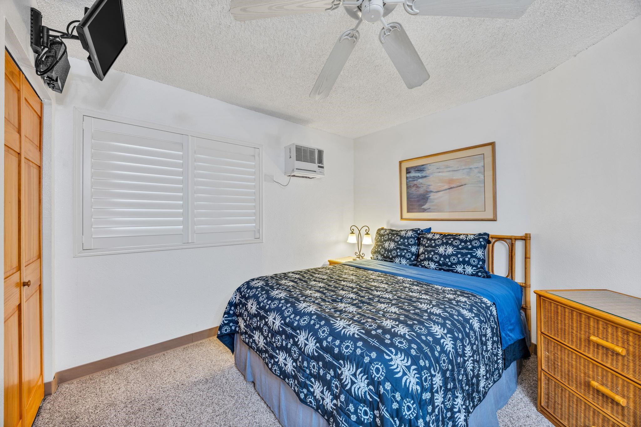 1032 South Kihei Road, Unit A412 Kihei, HI 96753 - Photo 20 of 43 a bedroom with a bed a dresser and potted plant