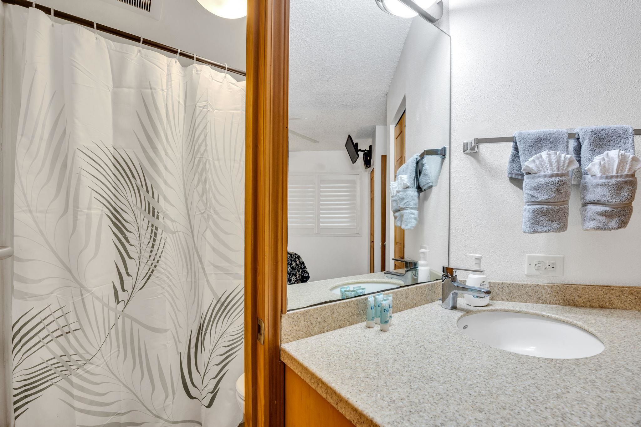 1032 South Kihei Road, Unit A412 Kihei, HI 96753 - Photo 21 of 43 a bathroom with a granite countertop sink and a mirror
