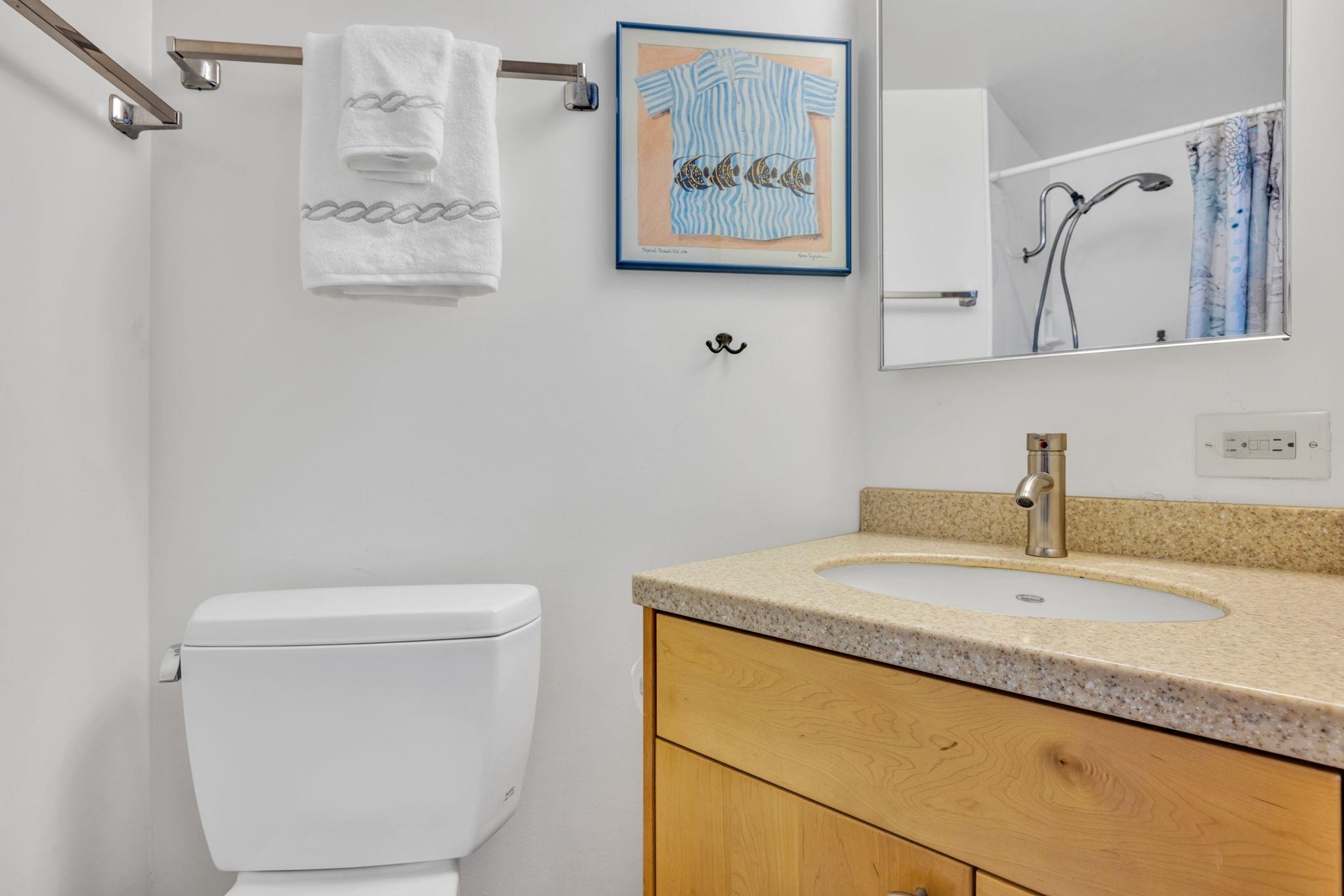 1032 South Kihei Road, Unit A412 Kihei, HI 96753 - Photo 24 of 43 a bathroom with a granite countertop sink a toilet and a mirror