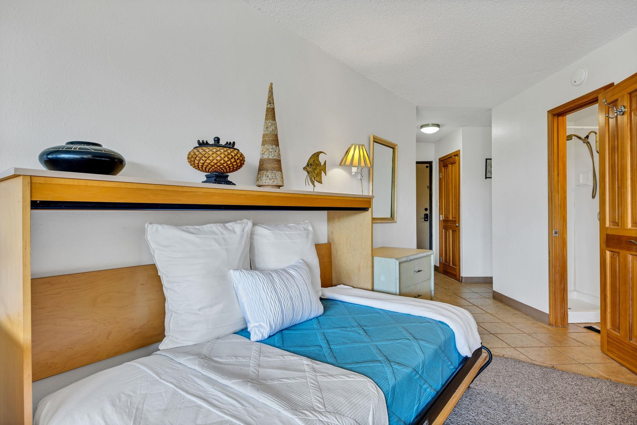 1032 South Kihei Road, Unit A412 Kihei, HI 96753 - Photo 27 of 43 a bedroom with a bed and cabinets