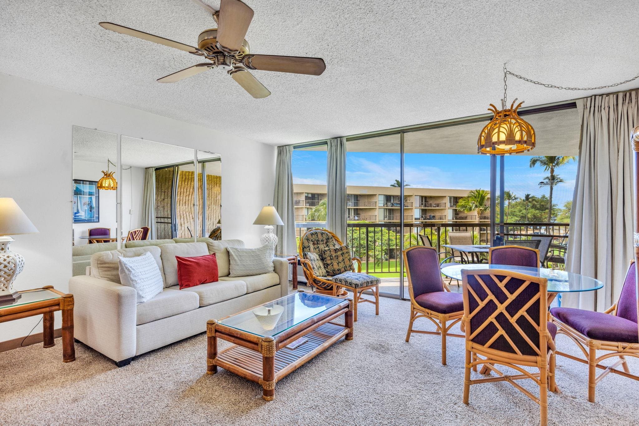 1032 South Kihei Road, Unit A412 Kihei, HI 96753 - Photo 3 of 43 a living room with furniture a ceiling fan and a window