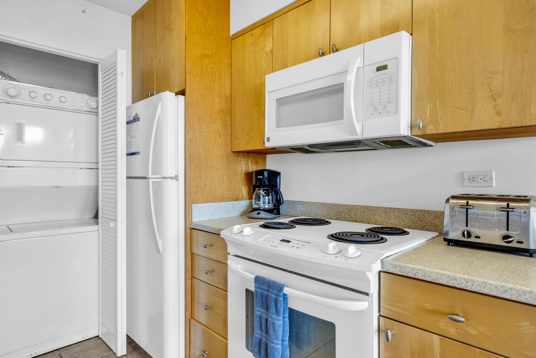 1032 South Kihei Road, Unit A412 Kihei, HI 96753 - Photo 7 of 43 a kitchen with a sink a stove and a refrigerator