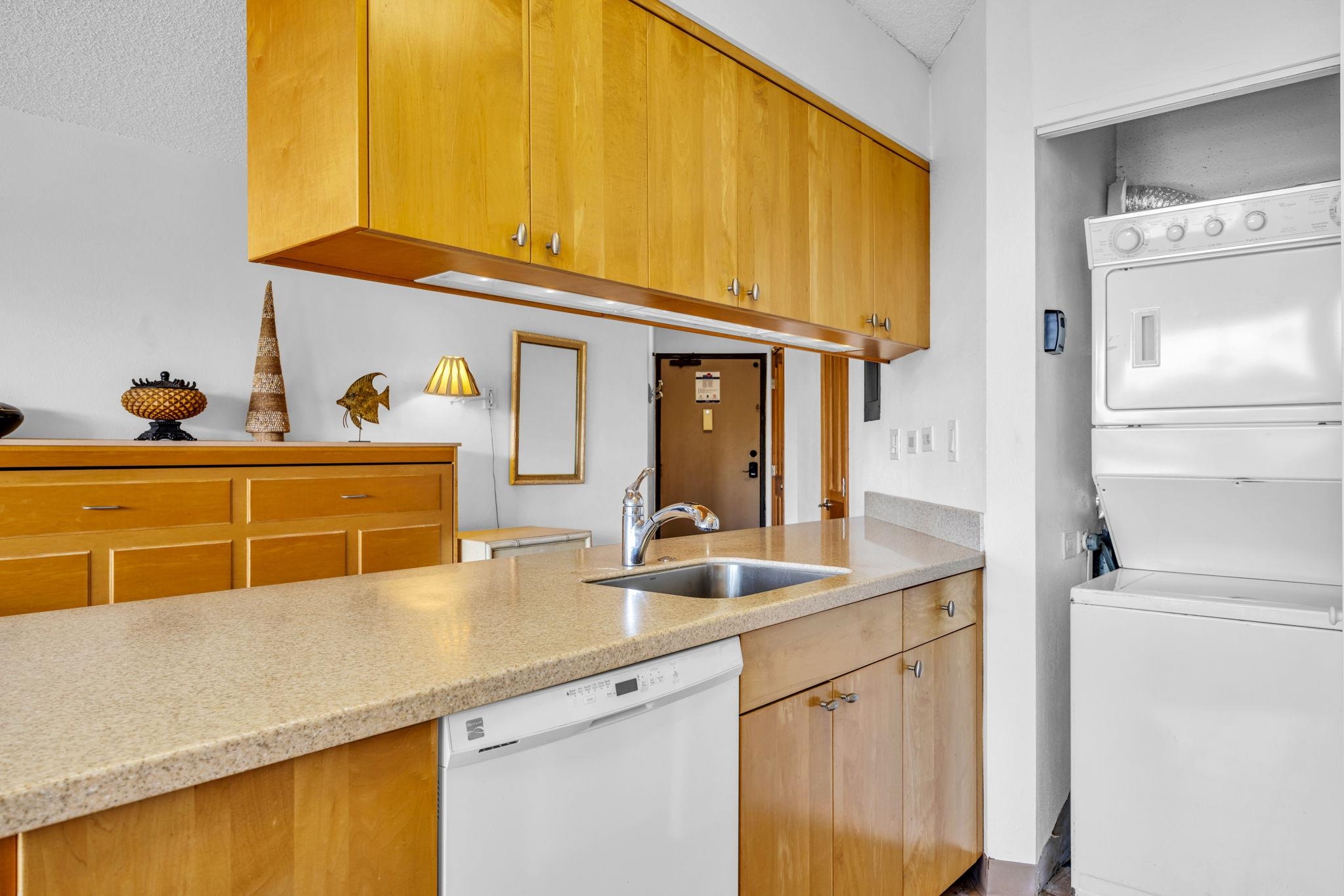 1032 South Kihei Road, Unit A412 Kihei, HI 96753 - Photo 8 of 43 a kitchen with stainless steel appliances a sink and cabinets